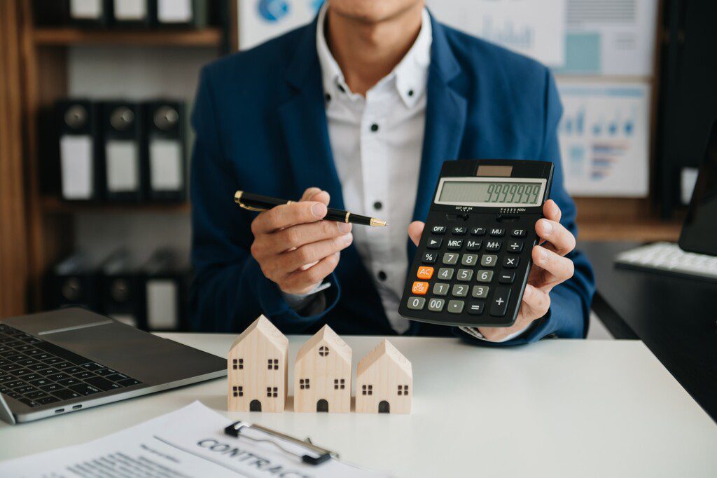 Homem ensinando sobre o seguro DFI com calculadora na mão